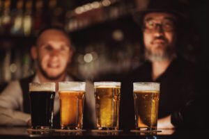 photo of four flavor beer with travelers enjoying english pubs in the USA