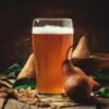 photo of beer in glass with fruit and foliage