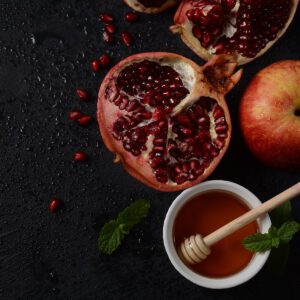 photo of pomegranate apple and honey