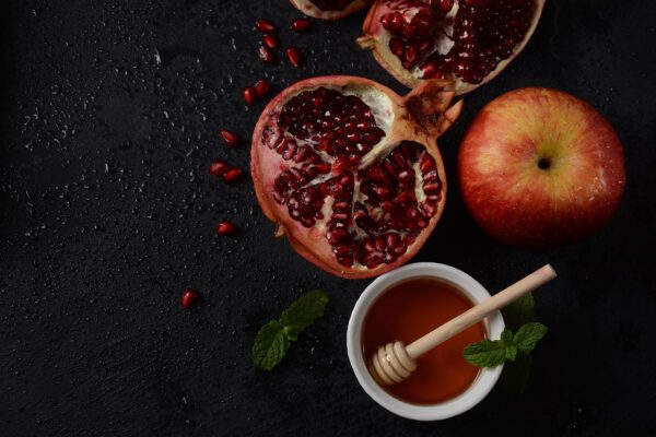 photo of pomegranate apple and honey