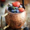 photo of copper beer mug with berries photo