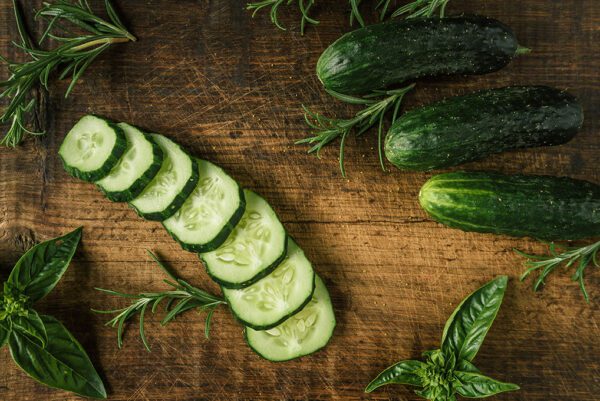 photo of cucumbers on wooden board